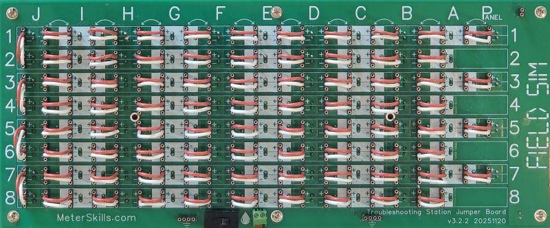 A photograph of the FS-24-TBS-JB Jumper Board with jumpers running between terminal blocks for the wire coming from each device on the front of the board, connecting the circuits