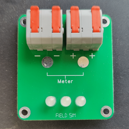 The Field Sim FS-24-NS device, which simulates a strobe, door strike, or DC valve/damper actuator. It has lever-actuated wire terminals at the top, large meter test points on the front, and a row of 3 LEDs to indicate when it's been activated.