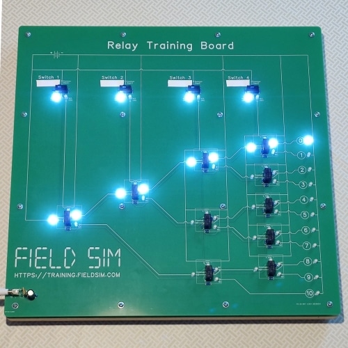 The FS-5-BFT Relay Training Board, showing 4 relays active, 6 relays inactive, LED 0 illuminated, and LEDs 1-10 extinguished.