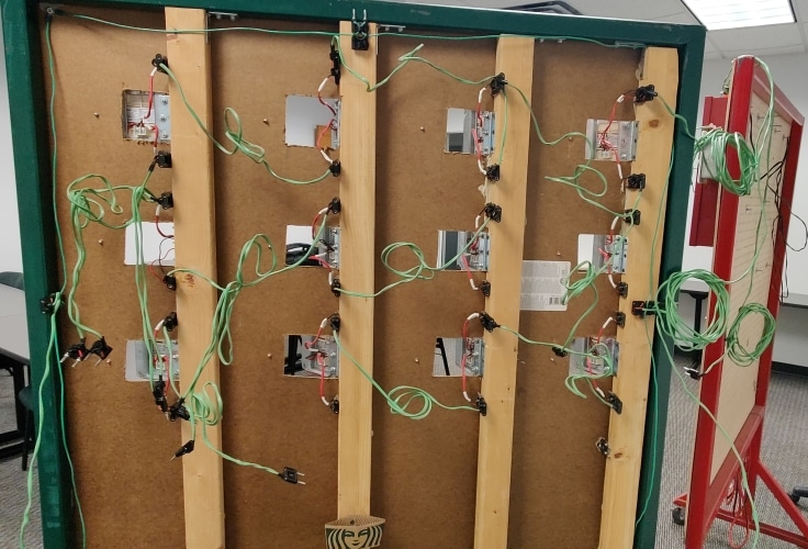 The back of the old troubleshooting board, showing the wires going to and from each strobe connected by configurable jumpers.